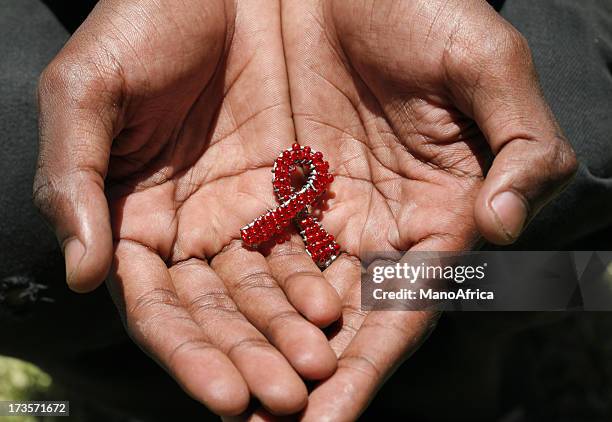 beaded aids in hands - hiv stockfoto's en -beelden