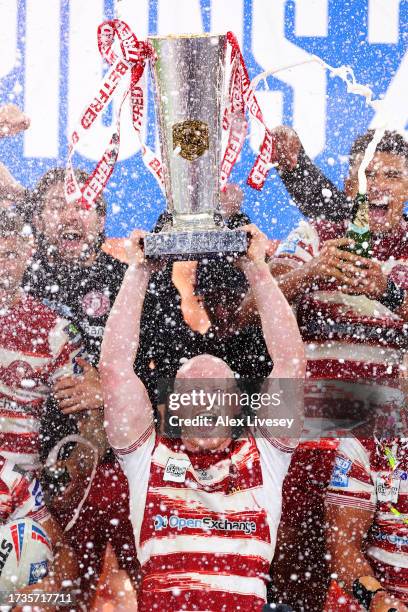 Liam Farrell of Wigan Warriors lifts the Betfred Super League Grand Final trophy during the Betfred Super League Final match between Wigan Warriors v...