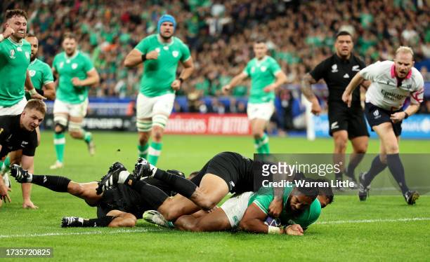 Bundee Aki of Ireland scores his team's first try during the Rugby World Cup France 2023 Quarter Final match between Ireland and New Zealand at Stade...