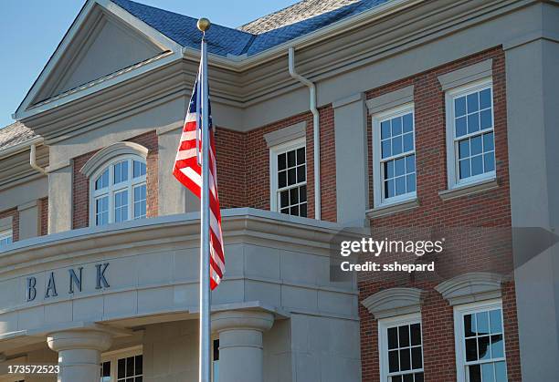 outside view of a bank with american flag - bank financial building stock pictures, royalty-free photos & images