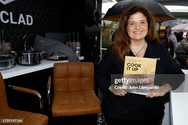 Alex Guarnaschelli signs her book during the Food Network New York City Wine & Food Festival presented by Capital One - Grand Tasting featuring...