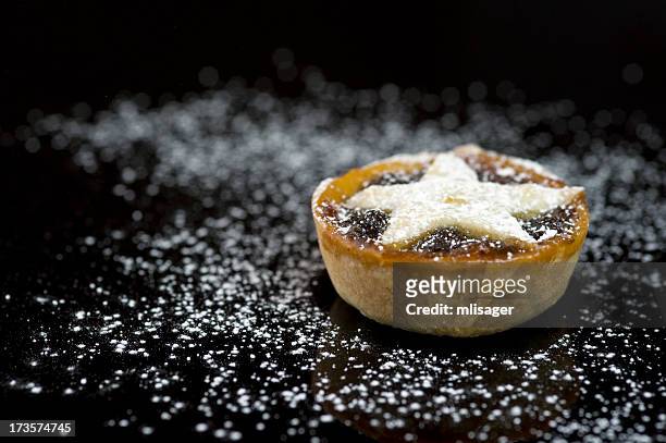 single christmas mince pie on black background - mince pie stock pictures, royalty-free photos & images
