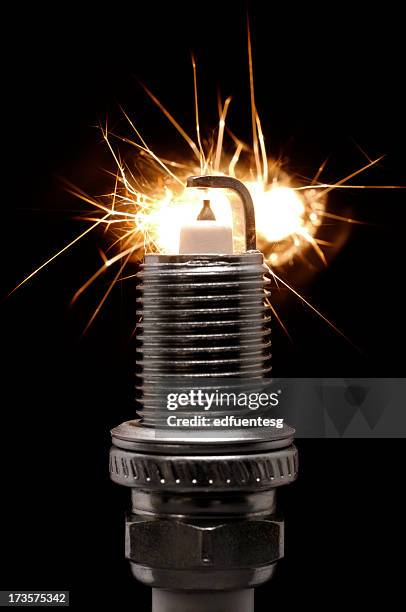 spark plug with active sparks against a black background - spark plug stock pictures, royalty-free photos & images