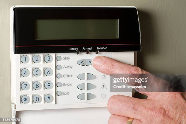 arming a home or business security system - alarm system stock pictures, royalty-free photos & images