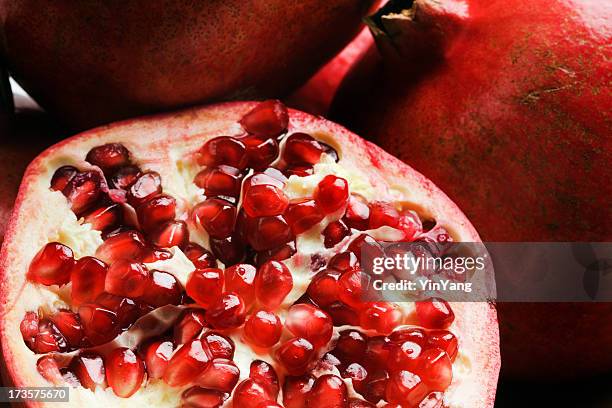 pomegranate, fresh tropical fruit food cut open in half close-up - half open stock pictures, royalty-free photos & images