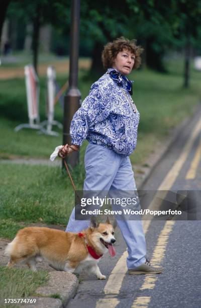 American actress Ava Gardner walks her dog in Hyde Park, London, England, circa 1986.