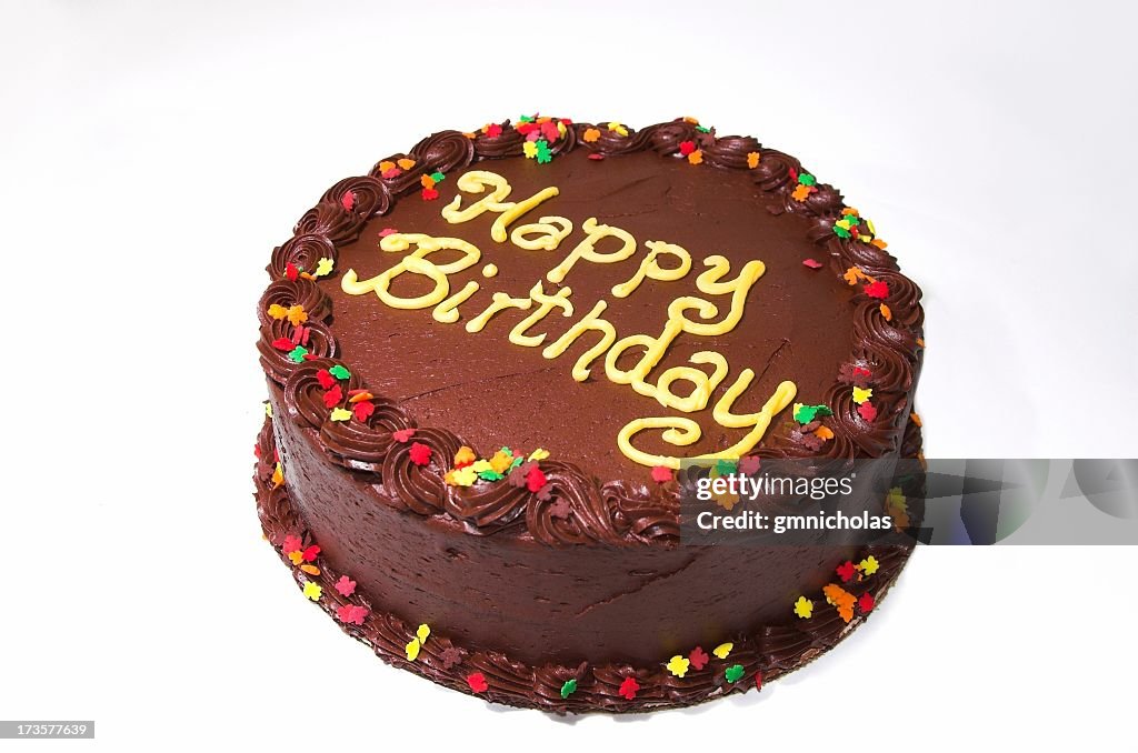 Chocolate birthday cake isolated on white