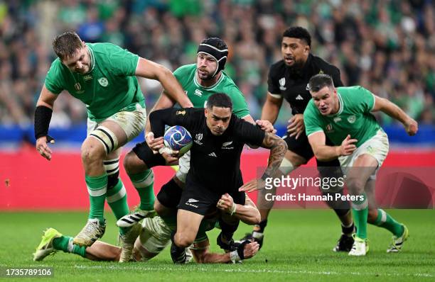 Aaron Smith of New Zealand is tackled by Josh Van der Flier of Ireland during the Rugby World Cup France 2023 Quarter Final match between Ireland and...