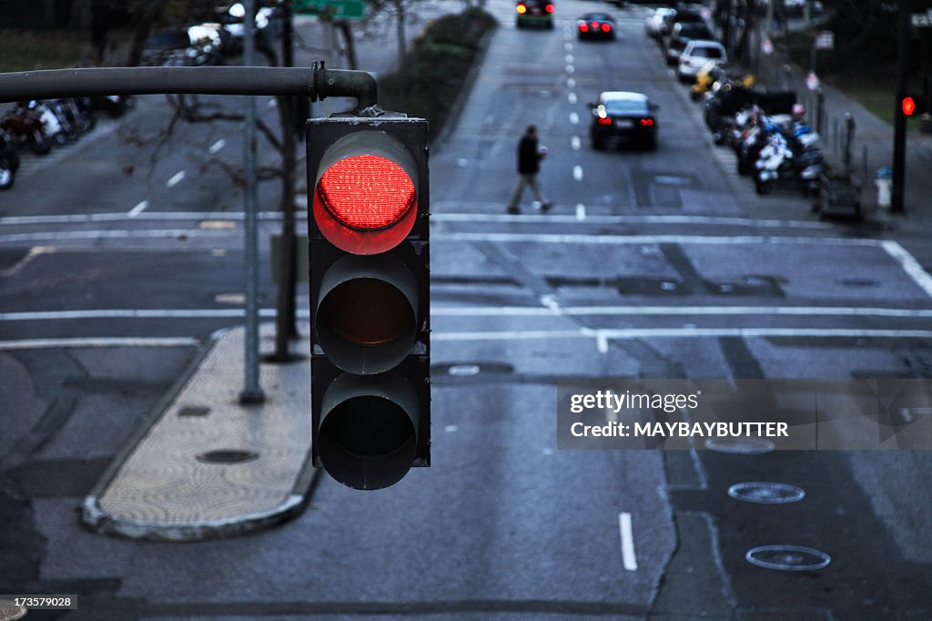 Red light hanging above a paved street in the city