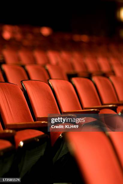 theater seats in an empty theater - cinema seats stockfoto's en -beelden