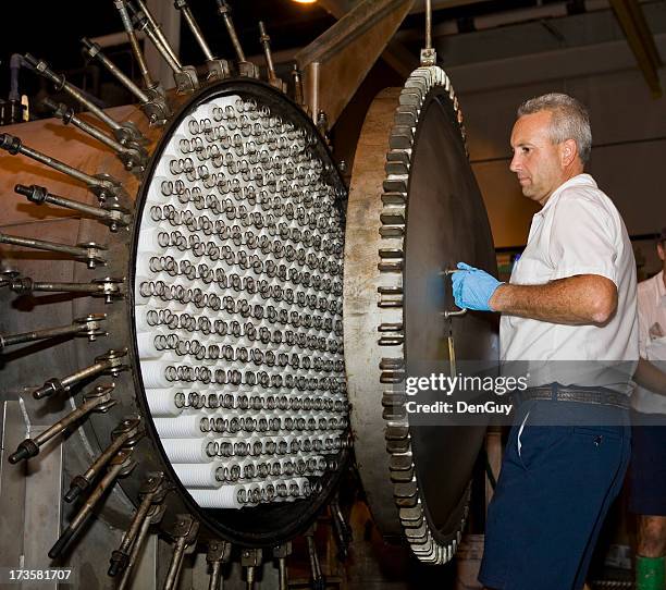 maintenance technician closing filtering tank at a water purification plant - reverse osmosis stock pictures, royalty-free photos & images