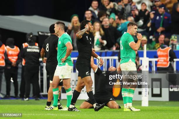 Ardie Savea of New Zealand celebrates as Garry Ringrose of Ireland looks dejected following the Rugby World Cup France 2023 Quarter Final match...