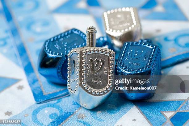 silver and blue dreidels - dreidel stock pictures, royalty-free photos & images