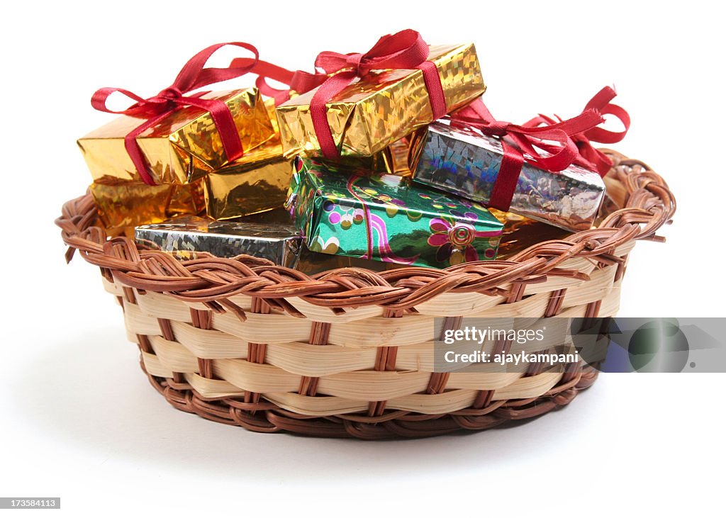 Shiny gift wrapped boxes in a weaved basket