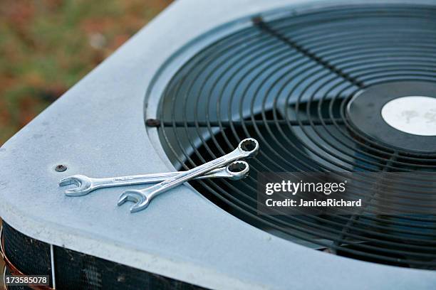 an air conditioner being fixed - air conditioner stock pictures, royalty-free photos & images