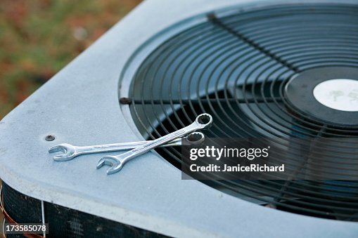 An air conditioner being fixed An air conditioner being fixed