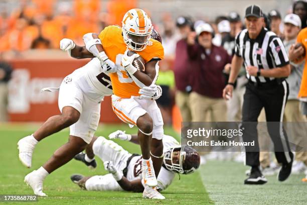 Dylan Sampson of the Tennessee Volunteers gets forced out of bounds by Taurean York and Josh DeBerry of the Texas A&M Aggies in the second quarter at...