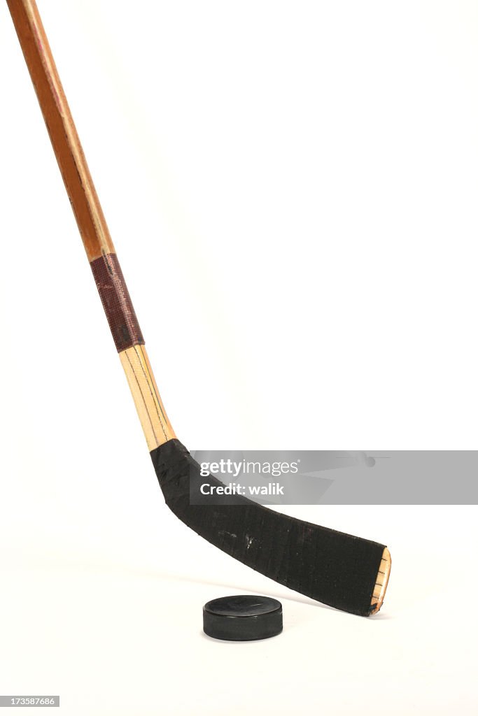 Hockey stick and pick on white background