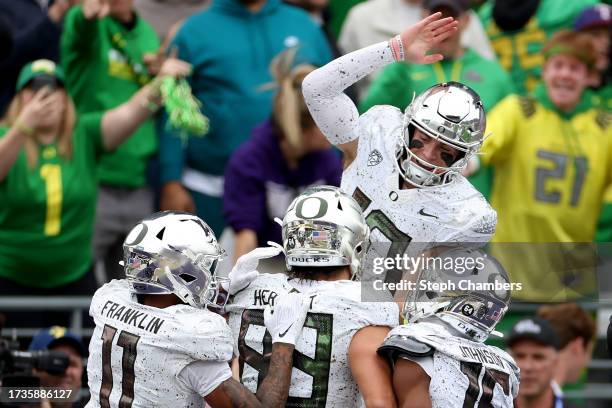 Bo Nix of the Oregon Ducks celebrates a touchdown during the second quarter against the Washington Huskies at Husky Stadium on October 14, 2023 in...