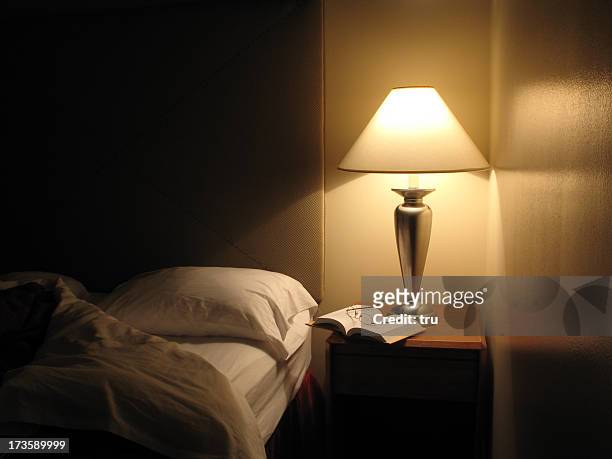 bed turned down in hotel room - bedside table lamp stock pictures, royalty-free photos & images