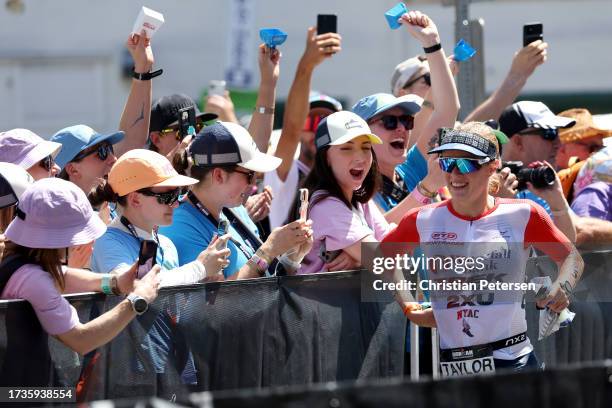 Taylor Knibb runs through the transition zone to start the bike portion during the VinFast IRONMAN World Championship on October 14, 2023 in Kailua...