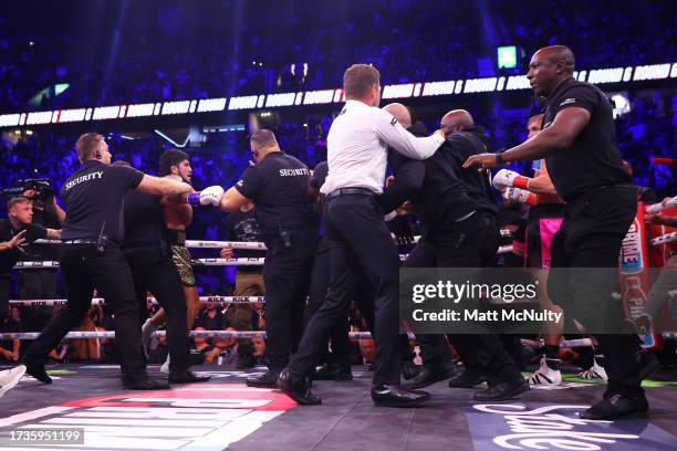 Security enters the ring to break up Logan Paul and Dillon Danis during the Misfits Heavyweight fight between Logan Paul and Dillon Danis at AO Arena...