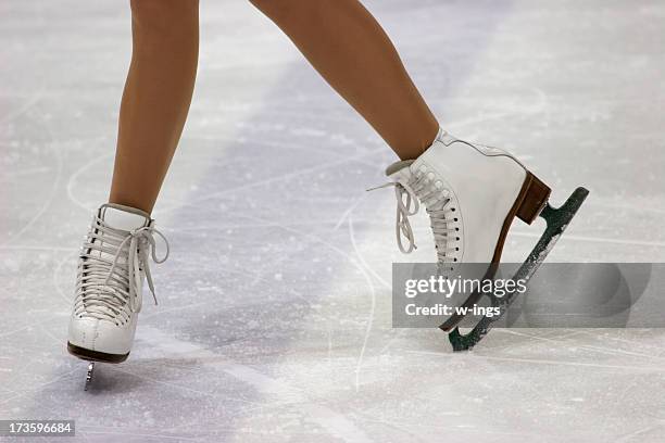 close up of figure skaters feet in skates on ice - ice hockey skate stock pictures, royalty-free photos & images