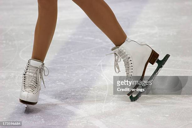 close up of figure skaters feet in skates on ice - ice skate bildbanksfoton och bilder