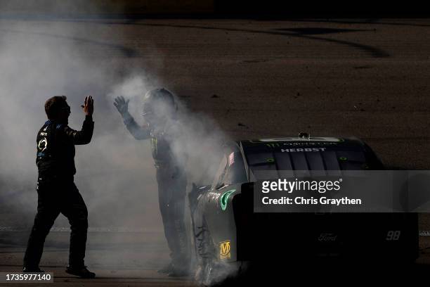 Riley Herbst, driver of the Monster Energy Ford, and crew celebrate after winning the NASCAR Xfinity Series Alsco Uniforms 302 at Las Vegas Motor...