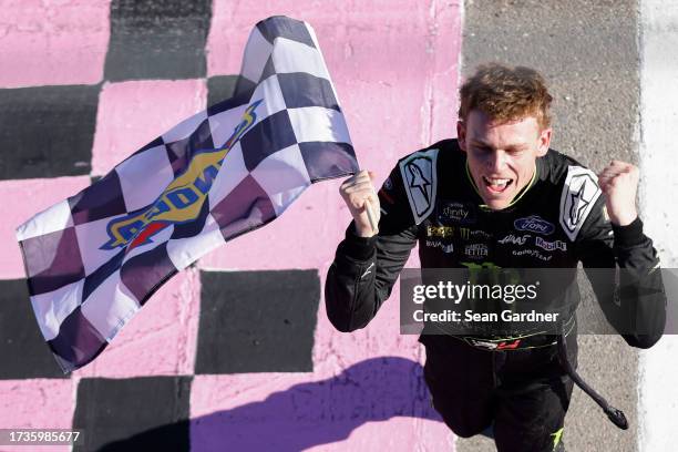 Riley Herbst, driver of the Monster Energy Ford, celebrates with the checkered flag after winning the NASCAR Xfinity Series Alsco Uniforms 302 at Las...