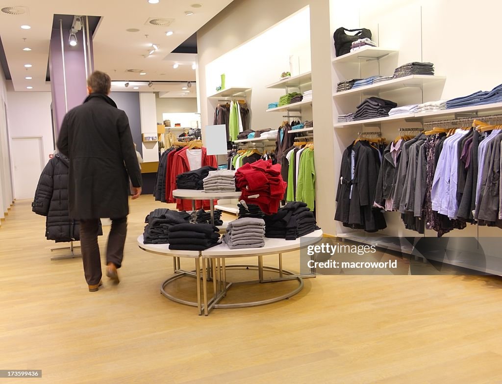 Man walking through clothing store