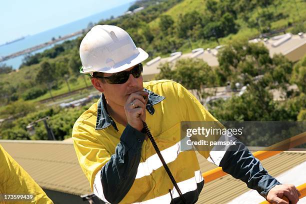 construction worker talking on walkie-talkie - walkie talkie stock pictures, royalty-free photos & images