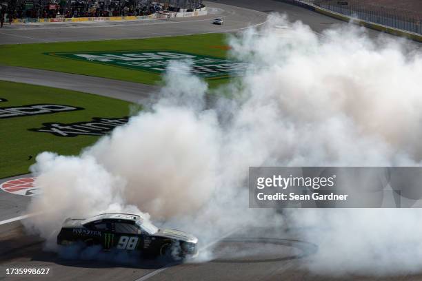 Riley Herbst, driver of the Monster Energy Ford, celebrates with a burnout after winning the NASCAR Xfinity Series Alsco Uniforms 302 at Las Vegas...
