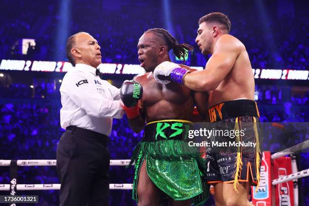 The referee breaks up KSI and Tommy Fury during the Misfits Cruiserweight fight between KSI and Tommy Fury at AO Arena on October 14, 2023 in...