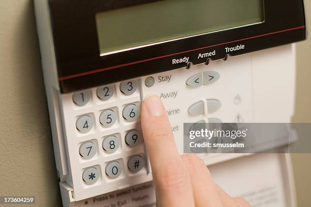 arming a home or business security system - alarm system stock pictures, royalty-free photos & images