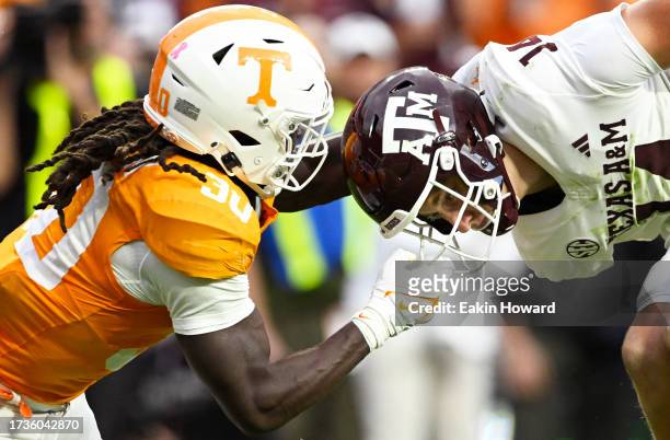 Roman Harrison of the Tennessee Volunteers gets called for a face mask penalty against Max Johnson of the Texas A&M Aggies in the fourth quarter at...