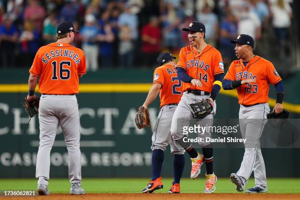 Grae Kessinger, Jose Altuve, Mauricio Dubon and Michael Brantley of the Houston Astros celebrate their win over the Texas Rangers in Game 5 of the...