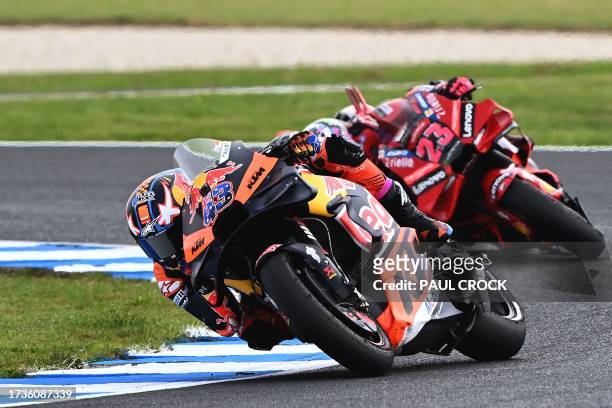 Red Bull KTM Factory Racing's Australia Jack Miller leads Ducati Lenovo Team's Italian rider Enea Bastianini during the first qualifying session of...