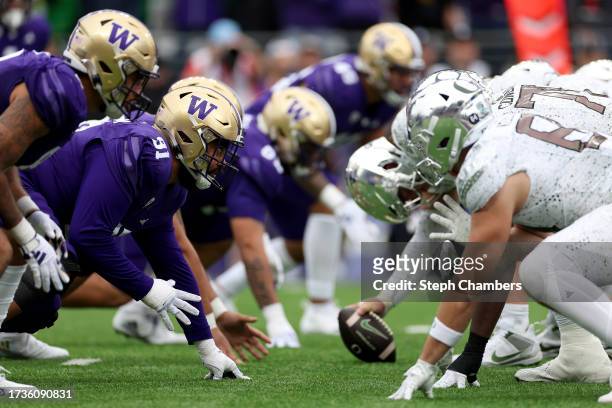 Washington Huskies and Oregon Ducks players line up for a play during the fourth quarter at Husky Stadium on October 14, 2023 in Seattle, Washington.