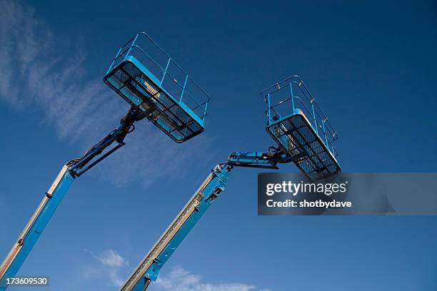 mostly blue - scissor lift construction stock pictures, royalty-free photos & images