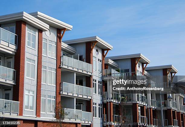 residential condos photographed against blue sky - vancouver canada stockfoto's en -beelden
