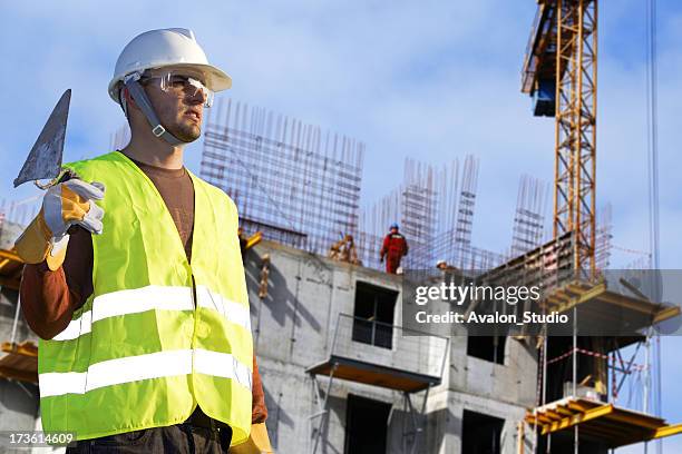 bricklayer in a building - erectie stockfoto's en -beelden