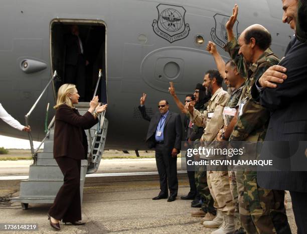 Secretary of State Hillary Clinton meets National Transitional Council officials at the steps of her C-17 military airplane upon her arrival in...