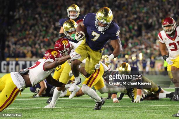 Audric Estime of the Notre Dame Fighting Irish runs with the ball against the USC Trojans during the first half at Notre Dame Stadium on October 14,...
