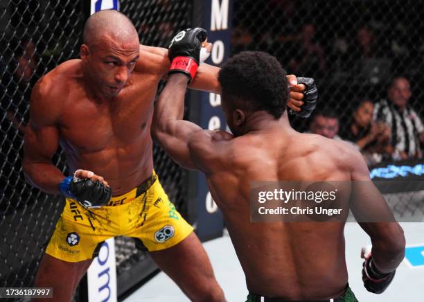 Edson Barboza of Brazil and Sodiq Yusuff of Nigeria trade punches in a featherweight fight during the UFC Fight Night event at UFC APEX on October...