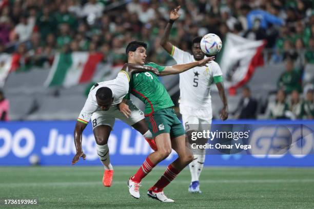 Raúl Jimenez of Mexico and Nicholas Opoku of Ghana of Ghana battle for the ball during the friendly match between Ghana and Mexico at Bank of America...