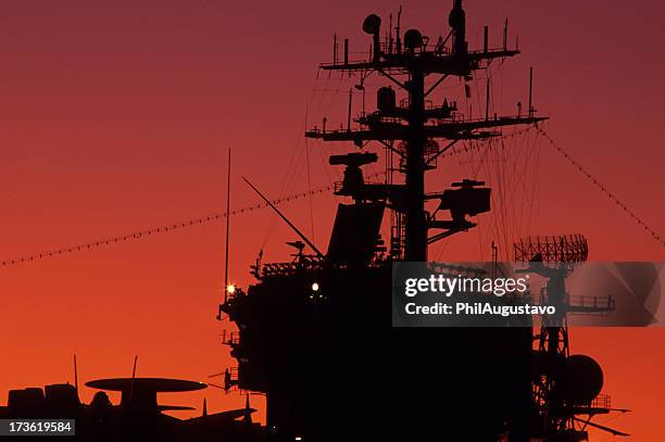 aircraft carrier at sunset - military ship stock pictures, royalty-free photos & images