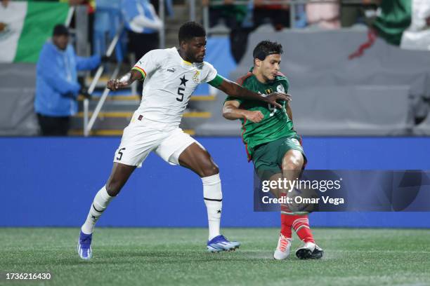 Raúl Jimenez of Mexico performs a rabona cross Thomas Partey of Ghana during the friendly match between Ghana and Mexico at Bank of America Stadium...