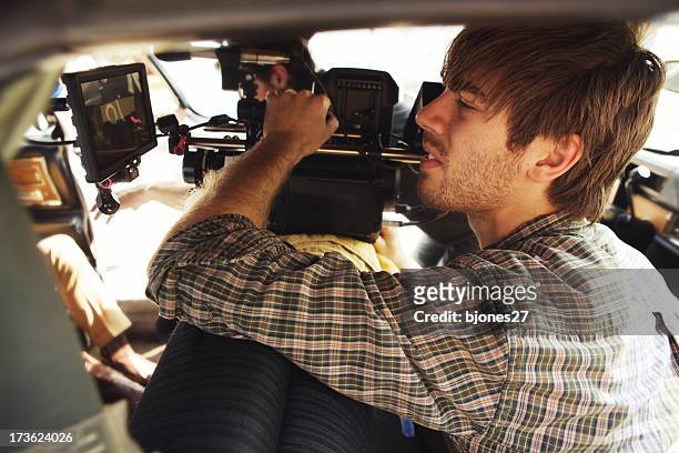 a male filming with a camera for production - film director stock pictures, royalty-free photos & images