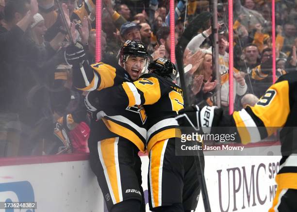 Evgeni Malkin of the Pittsburgh Penguins celebrates a goal with Rickard Rakell of the Pittsburgh Penguins during the third period against the Calgary...